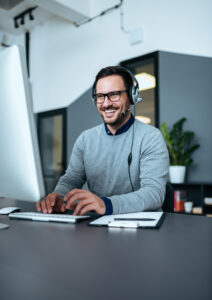 man smiling at desk