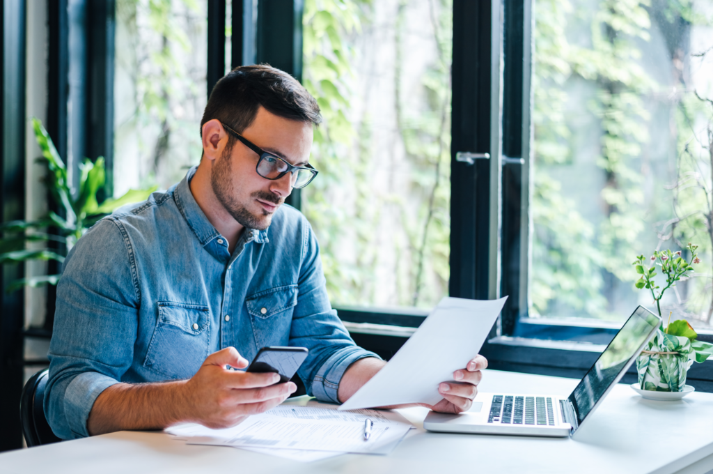 man smiling at laptop